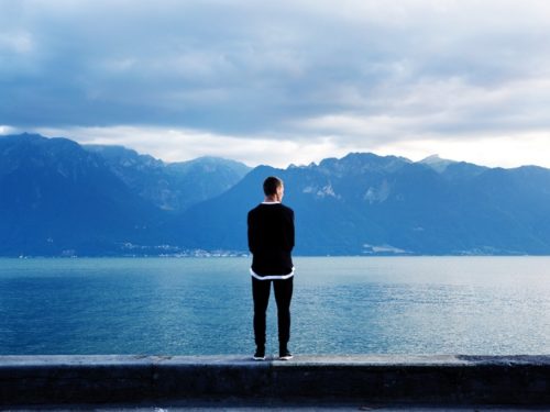 Person standing in front of a lake