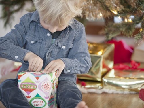 Young child opening a gift on Christmas